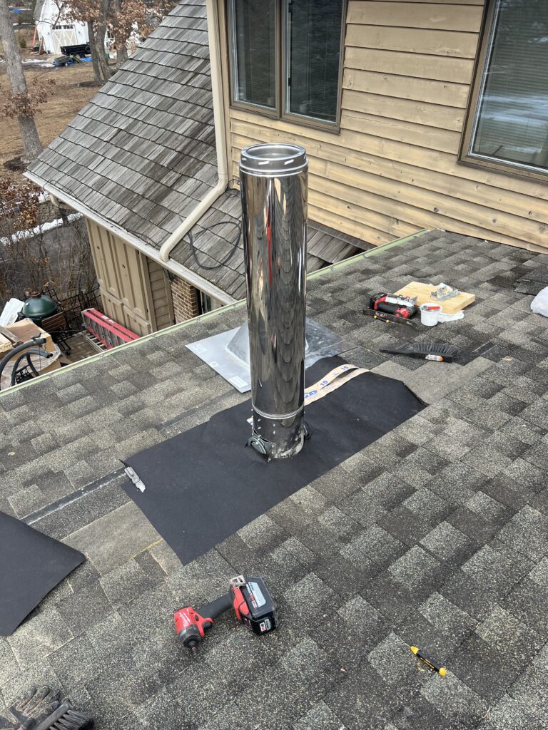 Custom wood-burning flue pipe installation with flashing and shingle work - chimney installation in Chicago, IL
