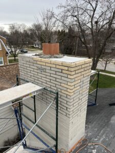 Completed chimney crown pour after brick replacement - masonry repair by Midwest Chimney Specialists