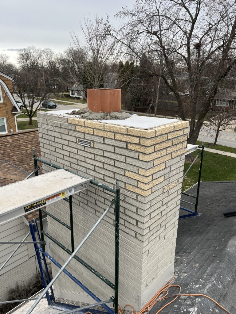 Completed chimney crown pour after brick replacement - masonry repair by Midwest Chimney Specialists