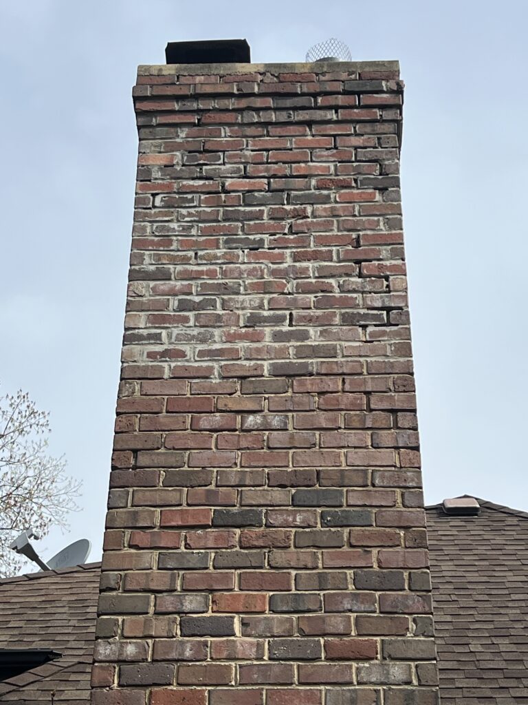 Chimney water damage and tuckpointing repair with rain cover install - latent defect rebuild in Chicago suburbs