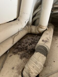 Multi-unit dryer vent cleaning removing fire hazard blockage - HOA chimney services in Chicagoland