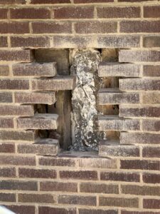 Access holes cut for furnace liner installation during brick replacement - chimney liner and masonry repair in Chicagoland
