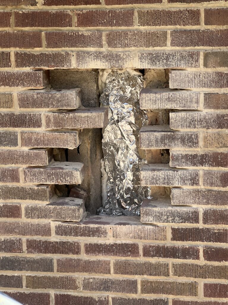 Access holes cut for furnace liner installation during brick replacement - chimney liner and masonry repair in Chicagoland