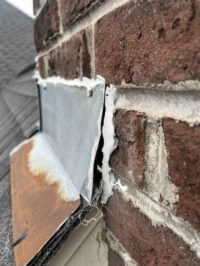 Chimney flashing failure causing water intrusion - flashing repair and sealing service in Chicagoland