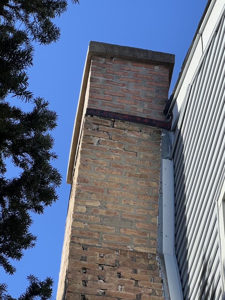 Chimney pulling away from home structure - fire hazard and safety concern from faulty chimney construction in Chicago, IL