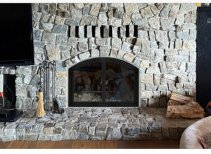 Custom glass doors on masonry wood-burning fireplace - fireplace door and surround installation in Chicagoland