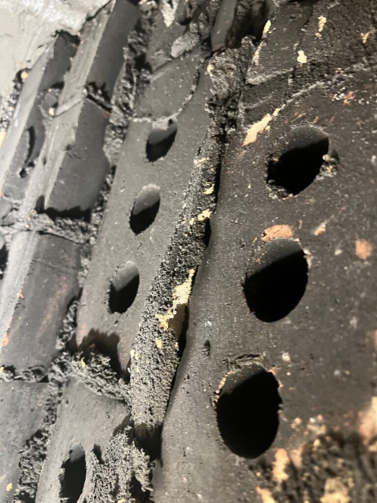 Exposed chimney block cores in smoke chamber creating fire hazard - safety inspection and sealant repair in Chicago, IL