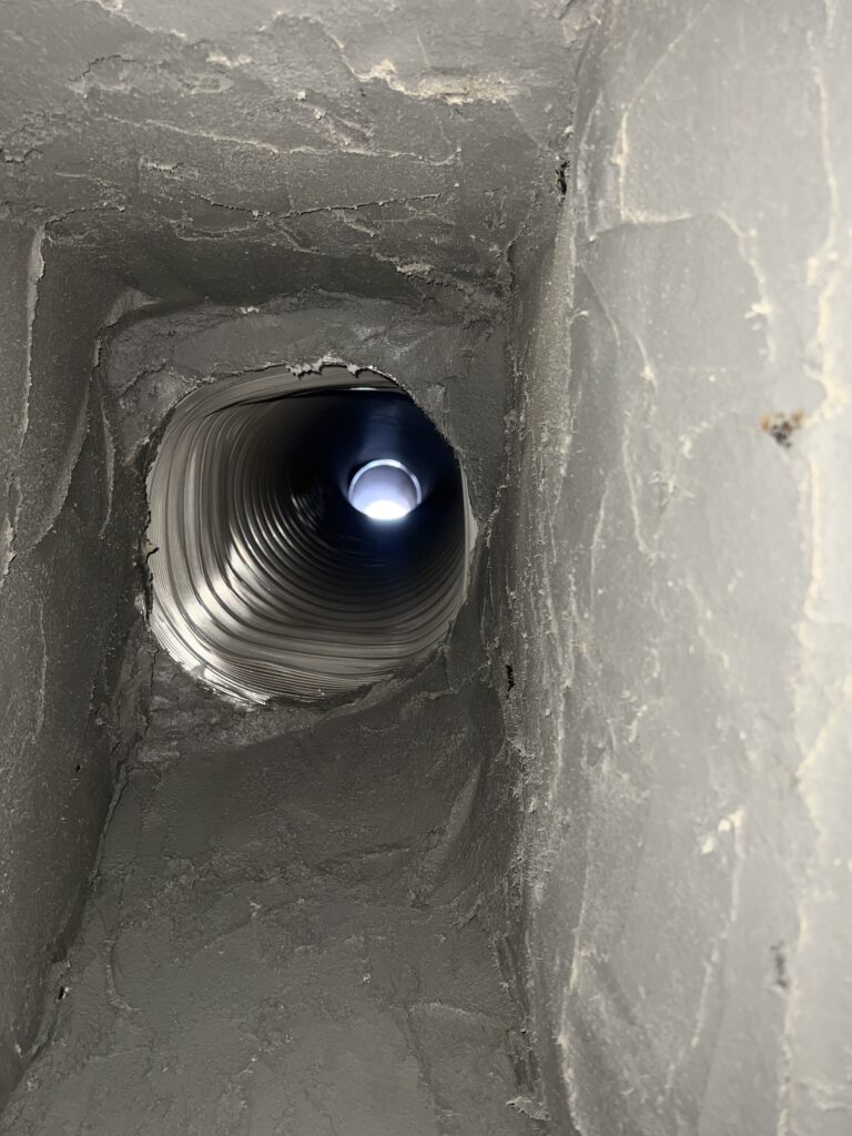 Wood-burning fireplace smoke chamber with exposed block cores and holes sealed - fire hazard latent defect repair in Chicagoland